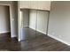 Neutral bedroom with wood floors and mirrored closet doors, maximizing space and light at 4750 N Central Ave # A10, Phoenix, AZ 85012