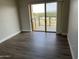 Bright bedroom with wood floors, balcony access, and scenic views for a relaxing retreat at 4750 N Central Ave # A10, Phoenix, AZ 85012