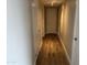 Hallway with recessed lighting and wood floors leads to various rooms, creating a bright and airy atmosphere at 4750 N Central Ave # A10, Phoenix, AZ 85012