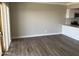 Modern living area features vinyl flooring, neutral walls, and an open layout for a comfortable living space at 4750 N Central Ave # A10, Phoenix, AZ 85012