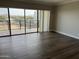 Bright living room features wood flooring and large windows providing spectacular city and mountain views at 4750 N Central Ave # A10, Phoenix, AZ 85012