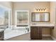 This primary bath features a large soaking tub, vanity, and natural light at 5010 W Ivanhoe St, Chandler, AZ 85226