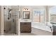 This primary bathroom features a shower, soaking tub, and modern finishes at 5010 W Ivanhoe St, Chandler, AZ 85226