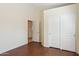 Spacious bedroom showcases wood floors and a closet or doorway leading to other parts of the residence at 5010 W Ivanhoe St, Chandler, AZ 85226