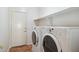 Functional laundry room featuring a washer, dryer, and shelving, making laundry chores a breeze at 5010 W Ivanhoe St, Chandler, AZ 85226