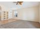 Bright and airy living room featuring a ceiling fan, and built-in shelving at 5010 W Ivanhoe St, Chandler, AZ 85226