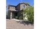 Charming two-story home featuring a tile roof, desert landscaping, and attached two-car garage at 5011 S 6Th Way, Phoenix, AZ 85040