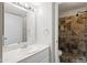 Bathroom featuring a marble vanity, updated lighting, and a tiled walk-in shower at 5525 E Thomas Rd # R11, Phoenix, AZ 85018