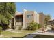 Exterior view of a modern apartment building with well-maintained landscaping and walkway at 5525 E Thomas Rd # R11, Phoenix, AZ 85018