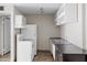 Compact kitchen featuring white appliances, upper cabinets and a stainless steel sink at 5525 E Thomas Rd # R11, Phoenix, AZ 85018