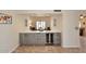Close up of the bar featuring a wine fridge, cabinets, drawers, and white countertop at 5879 E Marconi Ave, Scottsdale, AZ 85254