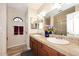 Bathroom featuring double sinks, tile floors, and sliding glass shower doors at 5879 E Marconi Ave, Scottsdale, AZ 85254