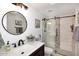 Updated bathroom with stylish shower featuring glass doors and mosaic tile accents at 5879 E Marconi Ave, Scottsdale, AZ 85254