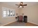 Bright bedroom with ceiling fan, hardwood floors, and window with white shutters at 5879 E Marconi Ave, Scottsdale, AZ 85254