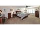 Spacious bedroom with large bed, dressers, and sitting area near the sunny windows at 5879 E Marconi Ave, Scottsdale, AZ 85254