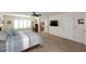 Spacious bedroom with large bed and an open door to an ensuite bathroom at 5879 E Marconi Ave, Scottsdale, AZ 85254