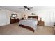 Spacious bedroom with large bed, dressers, and ceiling fan at 5879 E Marconi Ave, Scottsdale, AZ 85254