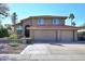 Charming two-story home featuring a three-car garage and a well-maintained front yard with a beautiful, red-tiled roof at 5879 E Marconi Ave, Scottsdale, AZ 85254