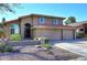 Charming two-story home featuring a three-car garage and a well-maintained front yard with a beautiful, red-tiled roof at 5879 E Marconi Ave, Scottsdale, AZ 85254
