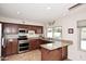 Well-lit kitchen showcasing granite countertops, stainless steel appliances, and ample cabinet space at 5879 E Marconi Ave, Scottsdale, AZ 85254