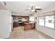 Classic kitchen with stainless steel appliances, wood cabinets, and tiled floor with adjacent eat-in nook at 5879 E Marconi Ave, Scottsdale, AZ 85254