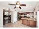Bright kitchen with stainless steel appliances, wood cabinets, and a convenient breakfast bar overlooking the living room at 5879 E Marconi Ave, Scottsdale, AZ 85254