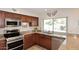 Stylish kitchen featuring stainless steel appliances, granite countertops, and wood cabinetry at 5879 E Marconi Ave, Scottsdale, AZ 85254
