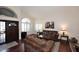 Inviting living room with hardwood floors, high ceilings, and an arched window that let in lots of natural light at 5879 E Marconi Ave, Scottsdale, AZ 85254