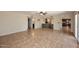 Open-concept living room featuring a bar with wine fridge and access to bathroom and kitchen at 5879 E Marconi Ave, Scottsdale, AZ 85254
