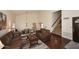 Spacious living room with high ceilings, hardwood floors, a staircase, and a view into the dining area at 5879 E Marconi Ave, Scottsdale, AZ 85254