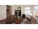 Inviting living room with hardwood floors, high ceilings, and an arched window that let in lots of natural light at 5879 E Marconi Ave, Scottsdale, AZ 85254