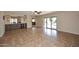 Expansive living room with tile flooring, sliding glass doors, and bar with wine fridge at 5879 E Marconi Ave, Scottsdale, AZ 85254