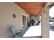 Relaxing covered patio area with comfortable seating and easy access to the home's interior at 5879 E Marconi Ave, Scottsdale, AZ 85254