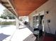 This outdoor patio includes a grill, furniture, an umbrella and access to a pool at 5879 E Marconi Ave, Scottsdale, AZ 85254