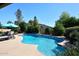 Bask in the sun by this refreshing pool, surrounded by lush foliage and clear blue skies at 5879 E Marconi Ave, Scottsdale, AZ 85254