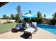 Lounge poolside with a clear view of the lovely pool and surrounding landscaped yard at 5879 E Marconi Ave, Scottsdale, AZ 85254