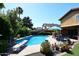 This is a beautiful pool complete with a diving board, chairs, and lush landscaping at 5879 E Marconi Ave, Scottsdale, AZ 85254