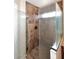 Bathroom featuring a frameless glass walk-in shower with tiled walls and floor at 5879 E Marconi Ave, Scottsdale, AZ 85254