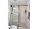 Close up of the updated shower featuring glass doors and mosaic tile accents at 5879 E Marconi Ave, Scottsdale, AZ 85254