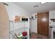 Storage space with wire rack, hanging clothes, ironing board, and additional door at 5879 E Marconi Ave, Scottsdale, AZ 85254