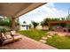 Expansive backyard with patio, outdoor kitchen, lush lawn, shed, and mature trees at 6311 E Calle Rosa --, Scottsdale, AZ 85251