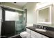 Bathroom featuring dark tile shower, white vanity, and stylish fixtures at 6311 E Calle Rosa --, Scottsdale, AZ 85251