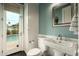 Charming bathroom featuring a pedestal sink and access to the outdoor pool area at 6311 E Calle Rosa --, Scottsdale, AZ 85251