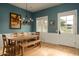 Dining room with a long wooden table and bench set, wood floors, and bright walls at 6311 E Calle Rosa --, Scottsdale, AZ 85251