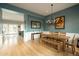 Dining room with wood floors, a modern chandelier, and access to other living areas at 6311 E Calle Rosa --, Scottsdale, AZ 85251