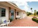 Charming patio space featuring brick paving, classic chairs, and access to a three-car garage at 6311 E Calle Rosa --, Scottsdale, AZ 85251