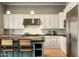 Updated kitchen with white cabinets, stainless steel appliances, and a center island with seating at 6311 E Calle Rosa --, Scottsdale, AZ 85251