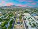 A high angle aerial view of a suburban neighborhood with mountain views in the distance at 717 E Palmaire Ave, Phoenix, AZ 85020