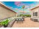 Inviting backyard patio with wicker sectional, string lights, and lush greenery for relaxing outdoor living at 717 E Palmaire Ave, Phoenix, AZ 85020