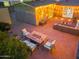 Charming backyard patio with a cozy fire pit, comfortable seating, string lights, and stylish outdoor decor at 717 E Palmaire Ave, Phoenix, AZ 85020